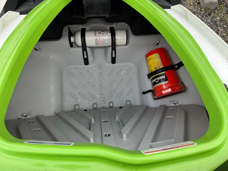 Slide: The Image of 2017 Bombardier Sea Doo GTR 230 storage compartment with fire extinguisher and safety equipment. - 24