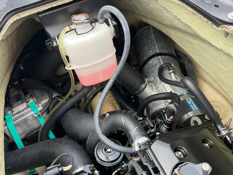 Slide: The Image of Engine compartment of a 2017 Bombardier Sea Doo GTR 230, showing coolant reservoir and hoses. - 39