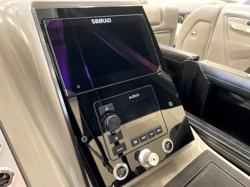 Slide: The Image of 2024 Barletta Corsa Ultra-Lounge 23UCA dashboard with Simrad display and controls. - 19