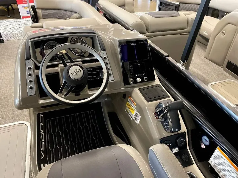 Slide: The Image of 2024 Barletta Corsa Ultra-Lounge 23UCA boat cockpit with steering wheel and control panel. - 5