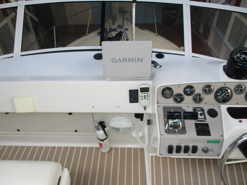 Slide: The Image of 1997 Carver Voyager helm with Garmin navigation, control panel, and gauges. - 12