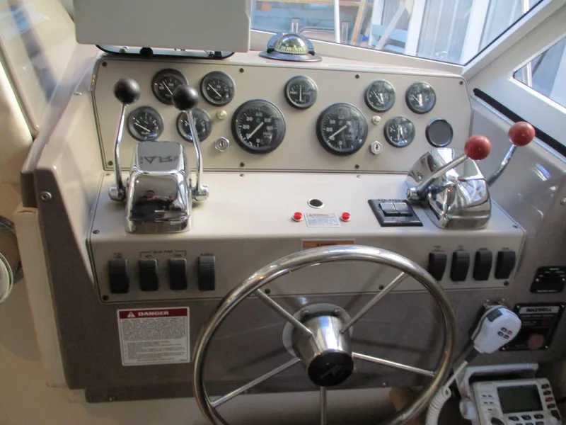 Slide: The Image of 1997 Carver Voyager helm with steering wheel, gauges, and control levers. - 20