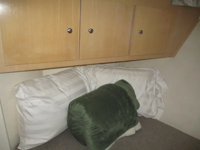 Slide: The Image of Cozy cabin interior of 1997 Carver Voyager with pillows and wooden cabinets. - 33