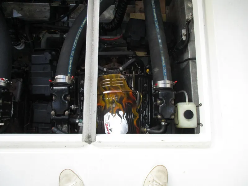 Slide: The Image of Engine compartment of a 1997 Carver Voyager boat, featuring hoses and components. - 39