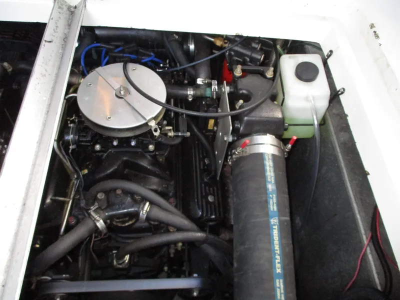 Slide: The Image of Engine compartment of a 1997 Carver Voyager boat, showcasing mechanical components and hoses. - 43