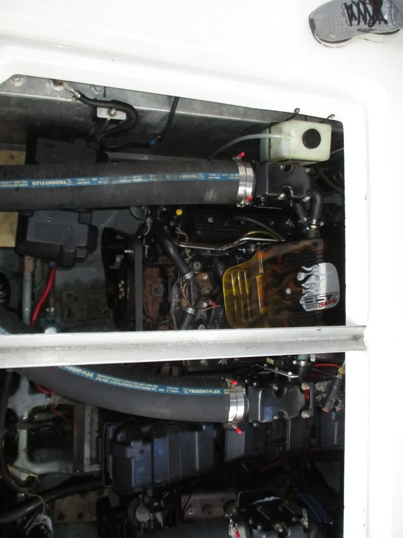 Slide: The Image of Engine compartment of a 1997 Carver Voyager boat, showing hoses and mechanical components. - 45