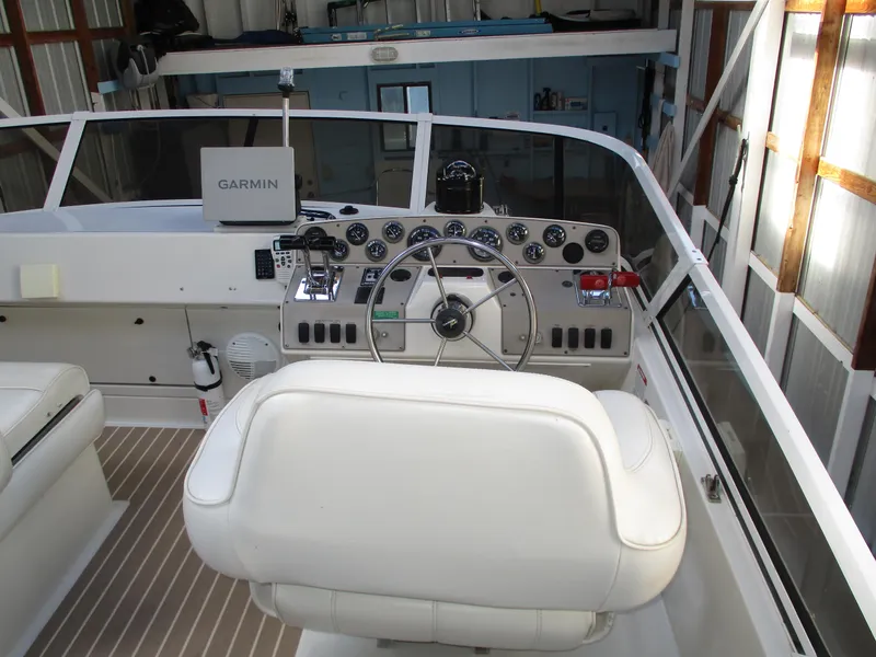 Slide: The Image of 1997 Carver Voyager boat cockpit with Garmin navigation system and white captain's chair. - 13