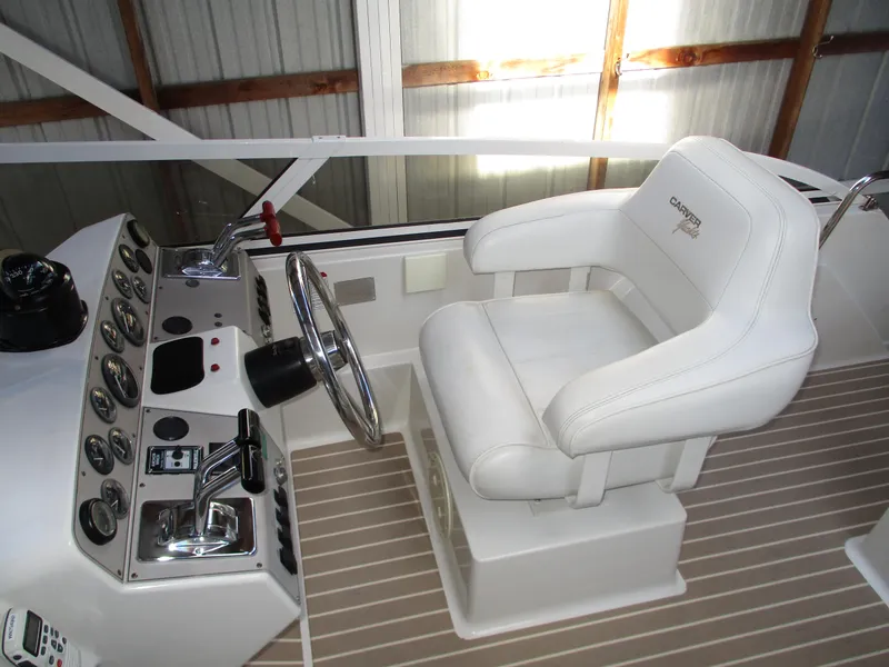 Slide: The Image of 1997 Carver Voyager helm with white captain's chair and control panel. - 14