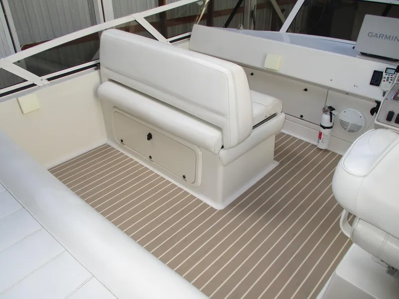 Slide: The Image of 1997 Carver Voyager boat interior with white seating and striped flooring. - 15