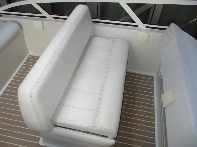 Slide: The Image of White seating on 1997 Carver Voyager boat with striped flooring. - 16