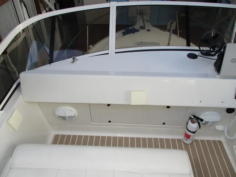 Slide: The Image of 1997 Carver Voyager boat interior with dashboard, seating, and safety equipment. - 17
