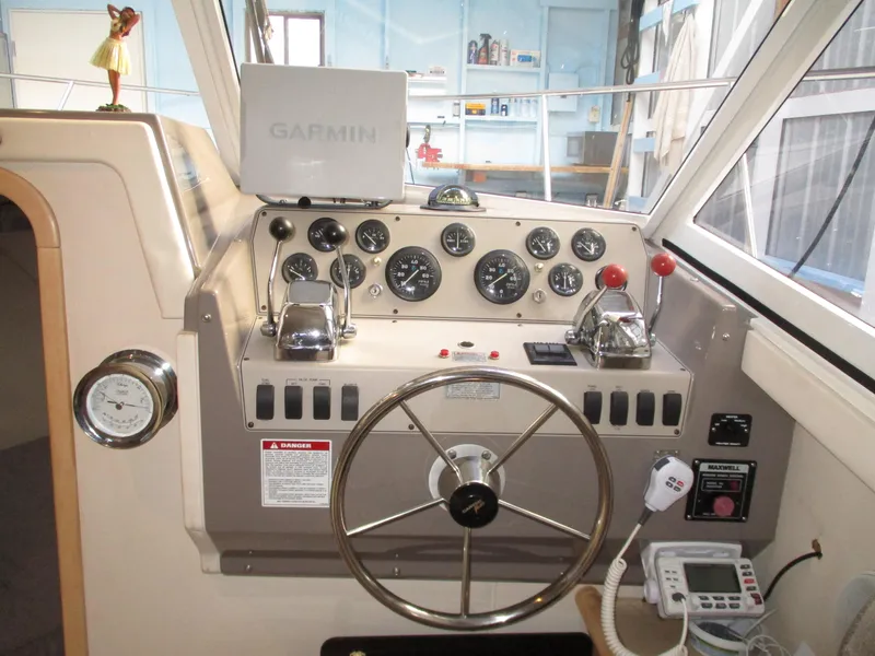 Slide: The Image of 1997 Carver Voyager helm with Garmin navigation, steering wheel, and control panel. - 21