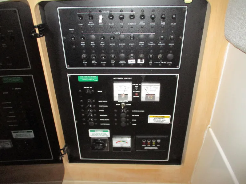 Slide: The Image of Electrical control panel inside a 1997 Carver Voyager boat, featuring various switches and gauges. - 23