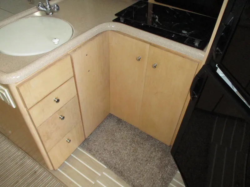 Slide: The Image of 1997 Carver Voyager kitchen area with sink, cabinets, and black countertop. - 29