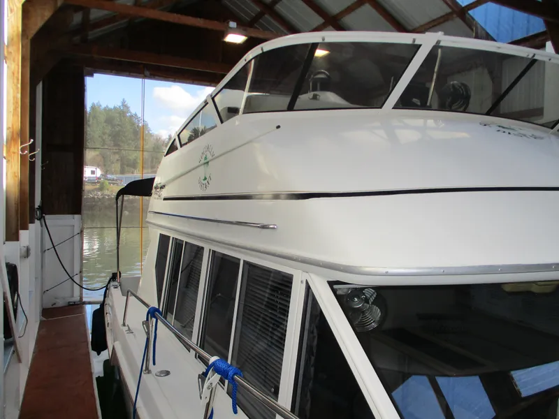 Slide: The Image of 1997 Carver Voyager boat docked in a covered marina. - 3