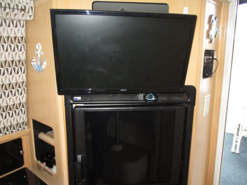 Slide: The Image of 1997 Carver Voyager interior with mounted TV and refrigerator. - 30