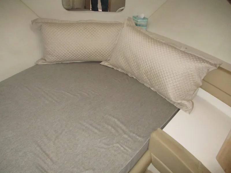 Slide: The Image of 1997 Carver Voyager interior cabin with bed and pillows. - 32