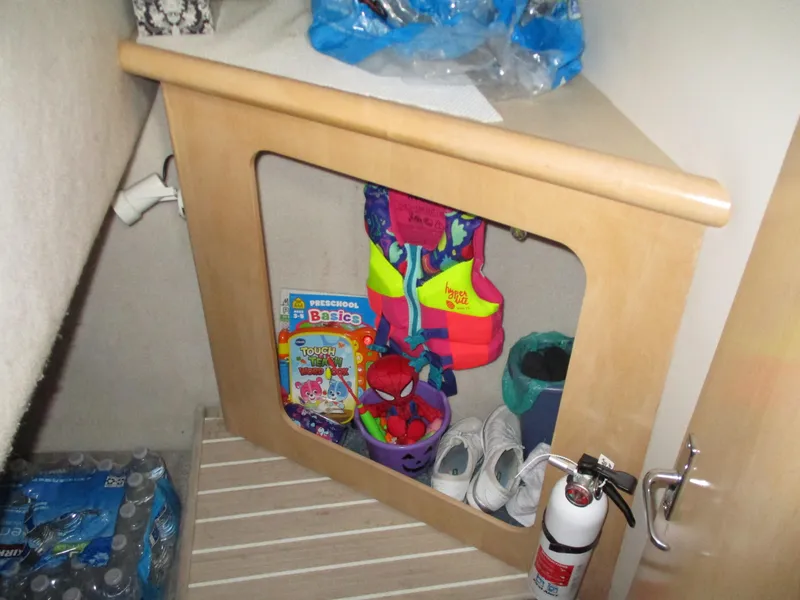 Slide: The Image of Storage area in a 1997 Carver Voyager with life jackets, toys, and bottled water. - 35