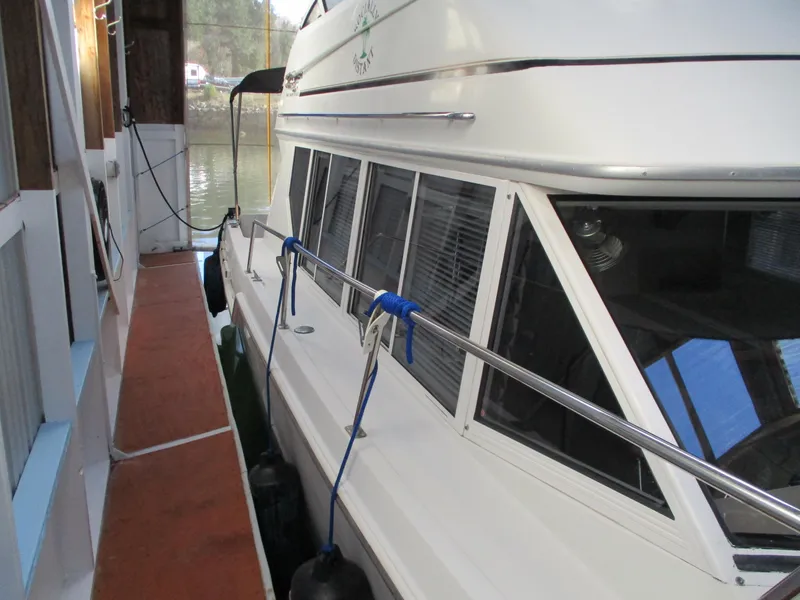 Slide: The Image of 1997 Carver Voyager yacht docked, side view with fenders and mooring lines. - 4