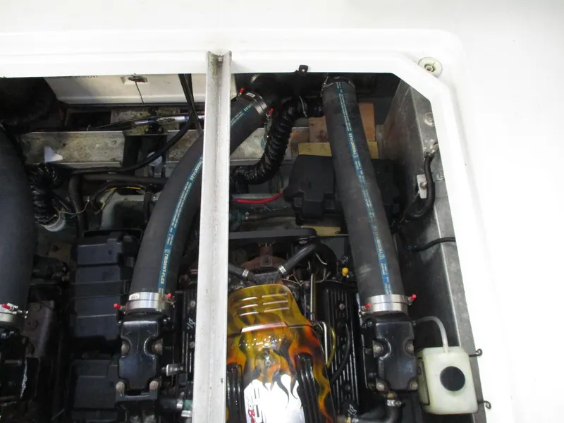 Slide: The Image of Engine compartment of a 1997 Carver Voyager boat, showing hoses and mechanical components. - 40
