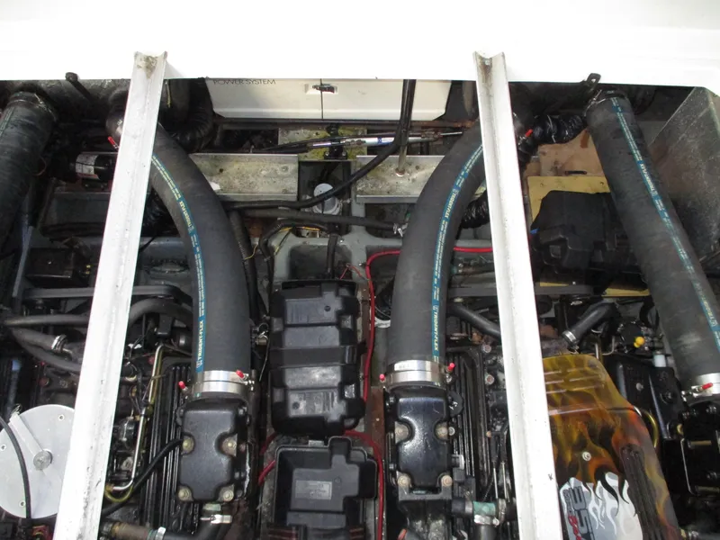 Slide: The Image of Engine compartment of a 1997 Carver Voyager boat, showcasing dual engines and components. - 41