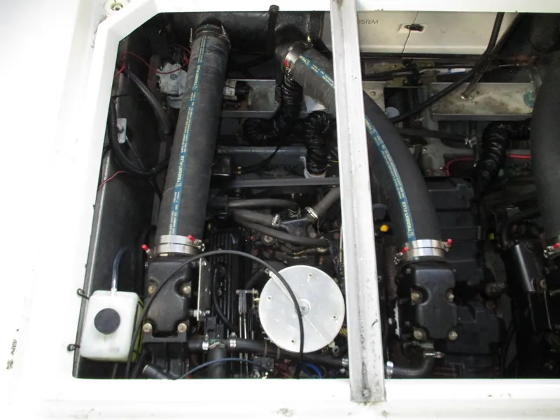 Slide: The Image of Engine compartment of a 1997 Carver Voyager boat, showcasing hoses and mechanical components. - 42