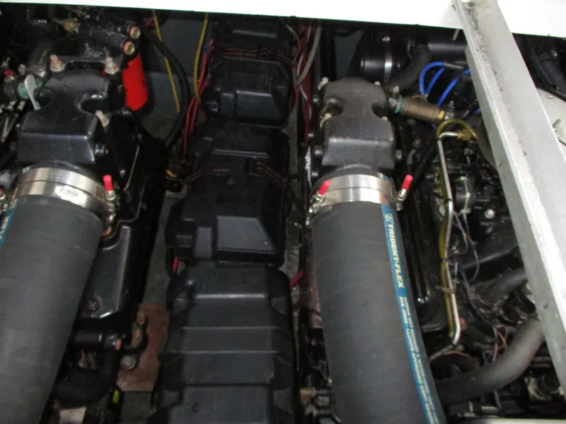 Slide: The Image of Engine compartment of a 1997 Carver Voyager boat, showcasing dual engines and wiring. - 44