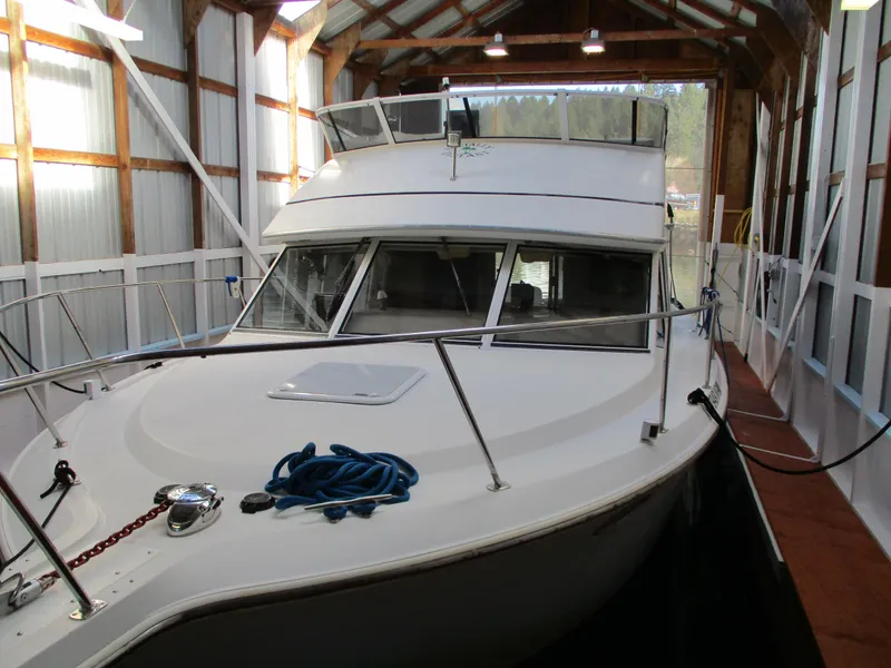 Slide: The Image of 1997 Carver Voyager boat docked in a covered marina. - 7