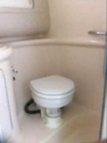 Slide: The Image of 1996 Sea Ray 270 Sundancer Special Edition boat bathroom with compact toilet. - 10