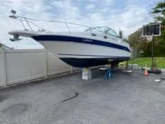 Slide: The Image of 1996 Sea Ray 270 Sundancer Special Edition boat on dry dock, outdoor setting. - 13
