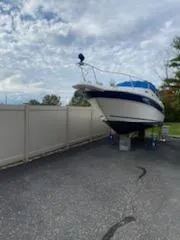 Slide: The Image of 1996 Sea Ray 270 Sundancer Special Edition boat on dry dock, cloudy sky background. - 14