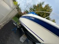 Slide: The Image of 1996 Sea Ray 270 Sundancer Special Edition boat on stands, outdoors, with trees in background. - 18