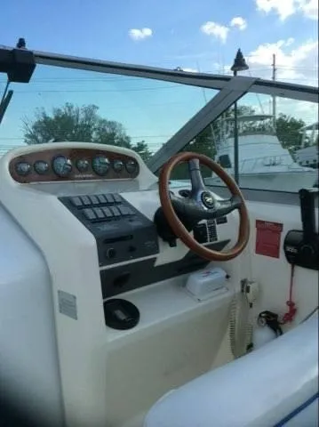Slide: The Image of 1996 Sea Ray 270 Sundancer Special Edition boat cockpit with steering wheel and instrument panel. - 3