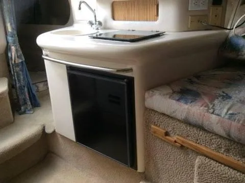 Slide: The Image of 1996 Sea Ray 270 Sundancer Special Edition cabin interior with kitchenette and seating area. - 6