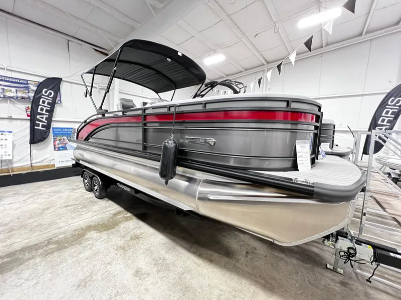 Slide: The Image of 2024 Harris Solstice 230 pontoon boat on display in a showroom. - 11