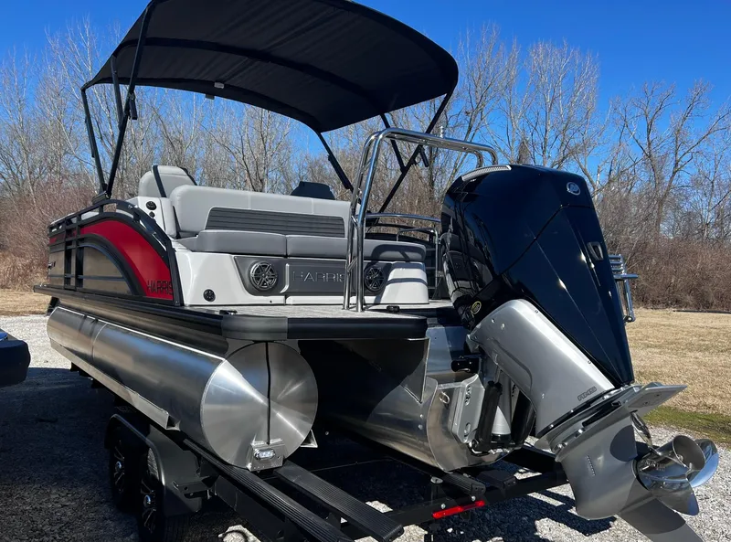 Slide: The Image of 2024 Harris Solstice 230 pontoon boat with outboard motor and canopy. - 13