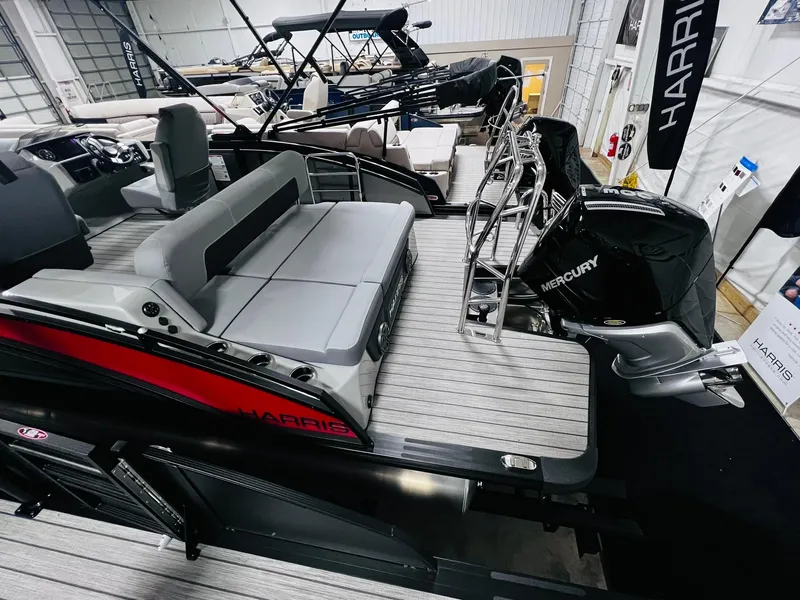 Slide: The Image of 2024 Harris Solstice 230 pontoon boat with Mercury outboard motor in showroom. - 14