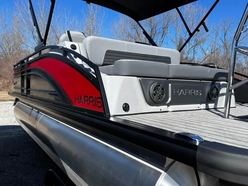 Slide: The Image of 2024 Harris Solstice 230 pontoon boat with red and black exterior. - 18