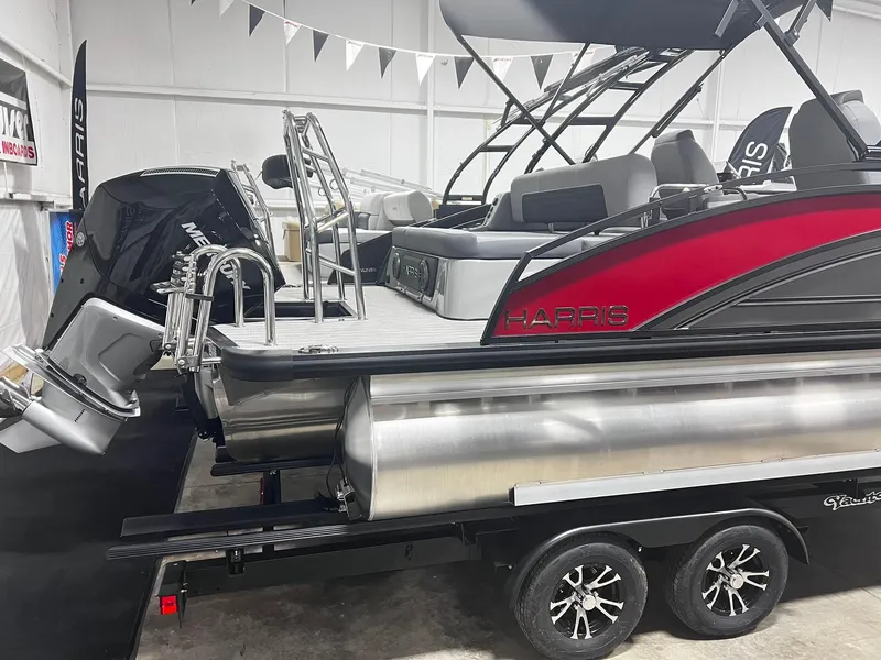 Slide: The Image of 2024 Harris Solstice 230 pontoon boat on trailer in showroom. - 19