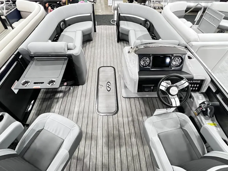 Slide: The Image of 2024 Harris Solstice 230 pontoon boat interior with modern seating and steering console. - 25