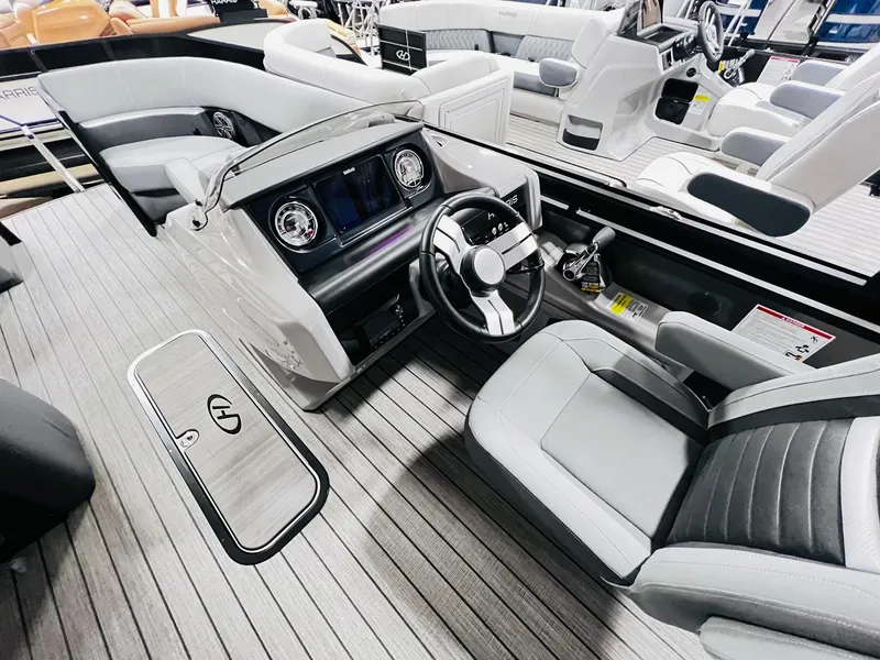 Slide: The Image of 2024 Harris Solstice 230 boat interior with modern dashboard and seating. - 27