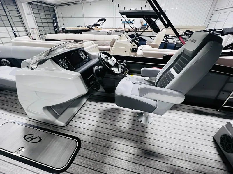 Slide: The Image of 2024 Harris Solstice 230 boat interior with captain's chair and control console. - 28