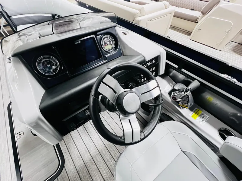Slide: The Image of 2024 Harris Solstice 230 boat dashboard with steering wheel and control panel. - 29
