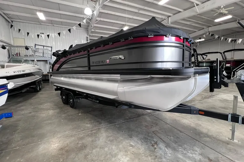 Slide: The Image of 2024 Harris Solstice 230 pontoon boat in showroom, covered and on trailer. - 3