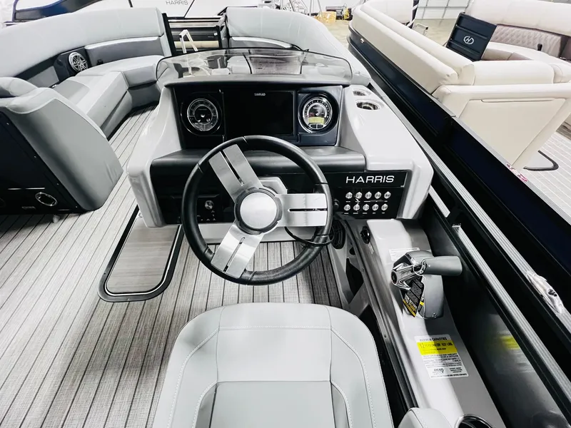 Slide: The Image of 2024 Harris Solstice 230 boat interior with steering wheel and dashboard. - 30
