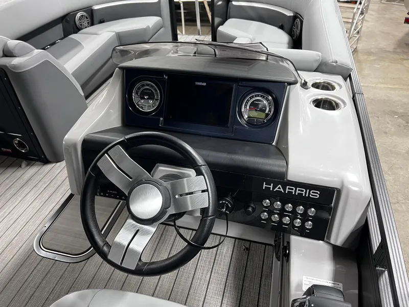 Slide: The Image of 2024 Harris Solstice 230 boat dashboard with steering wheel and control panel. - 31