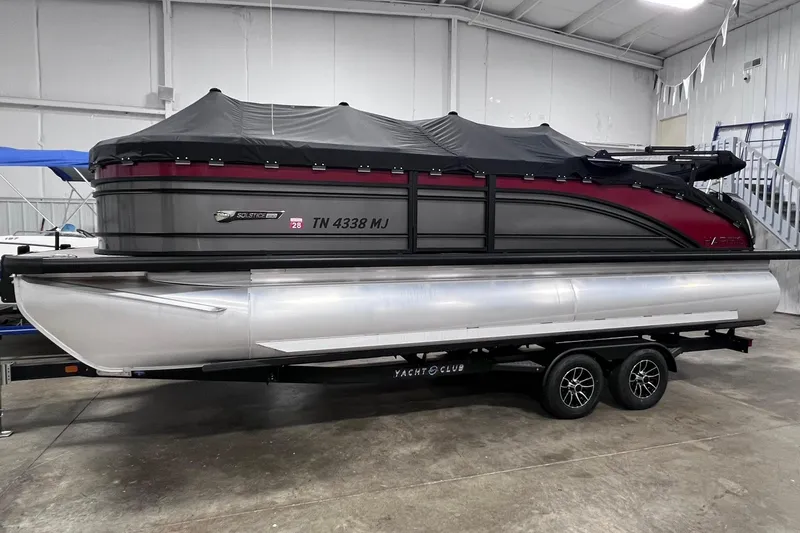 Slide: The Image of 2024 Harris Solstice 230 pontoon boat on trailer in indoor storage facility. - 5