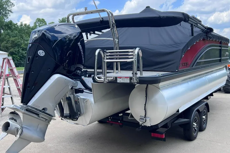 Slide: The Image of 2024 Harris Solstice 230 pontoon boat with Mercury outboard motor, parked on a trailer. - 8
