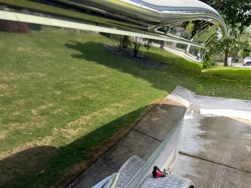 Slide: The Image of 2019 Scout 255LXF boat hull reflecting green lawn and driveway. - 11
