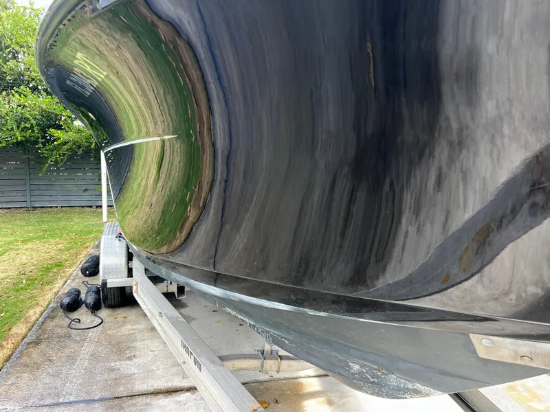 Slide: The Image of 2019 Scout 255LXF boat on a trailer, close-up of the hull. - 15